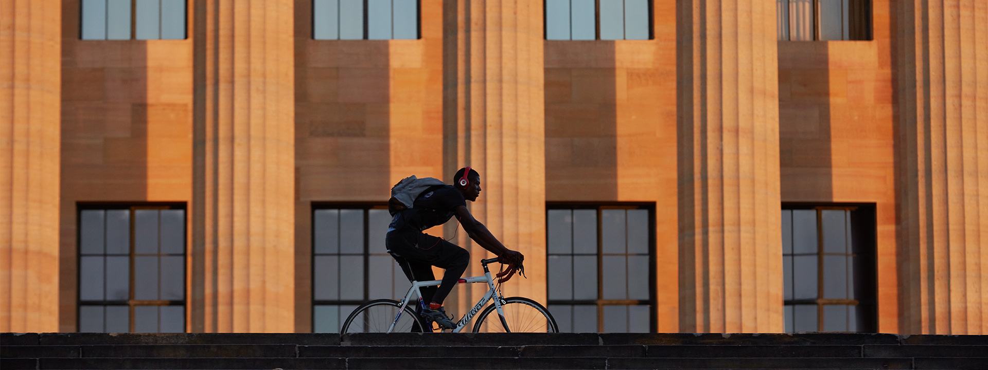 Biker riding in front of the museum